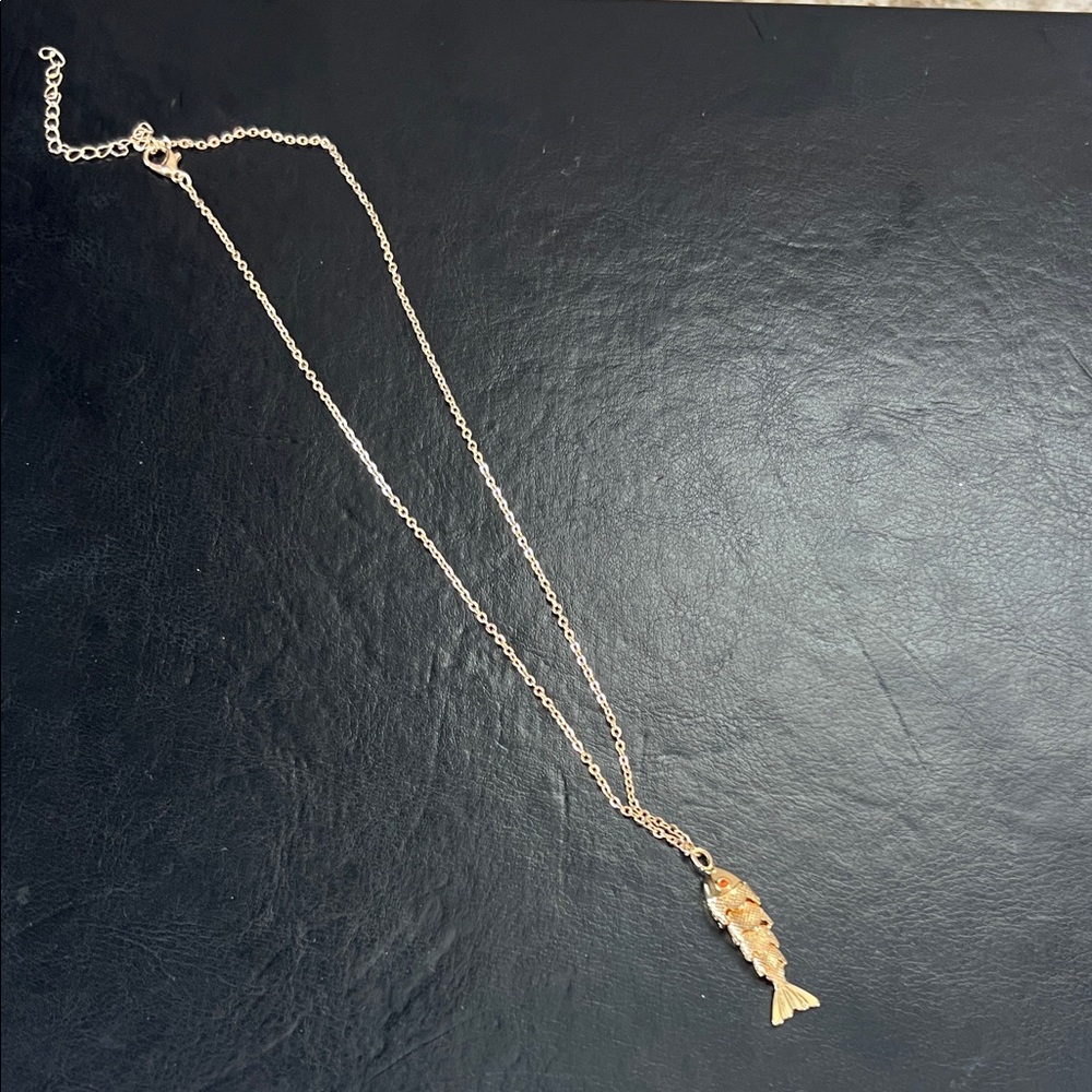 Trendy boutique Gold Fish Charm Necklace with Subtle Orange Accents